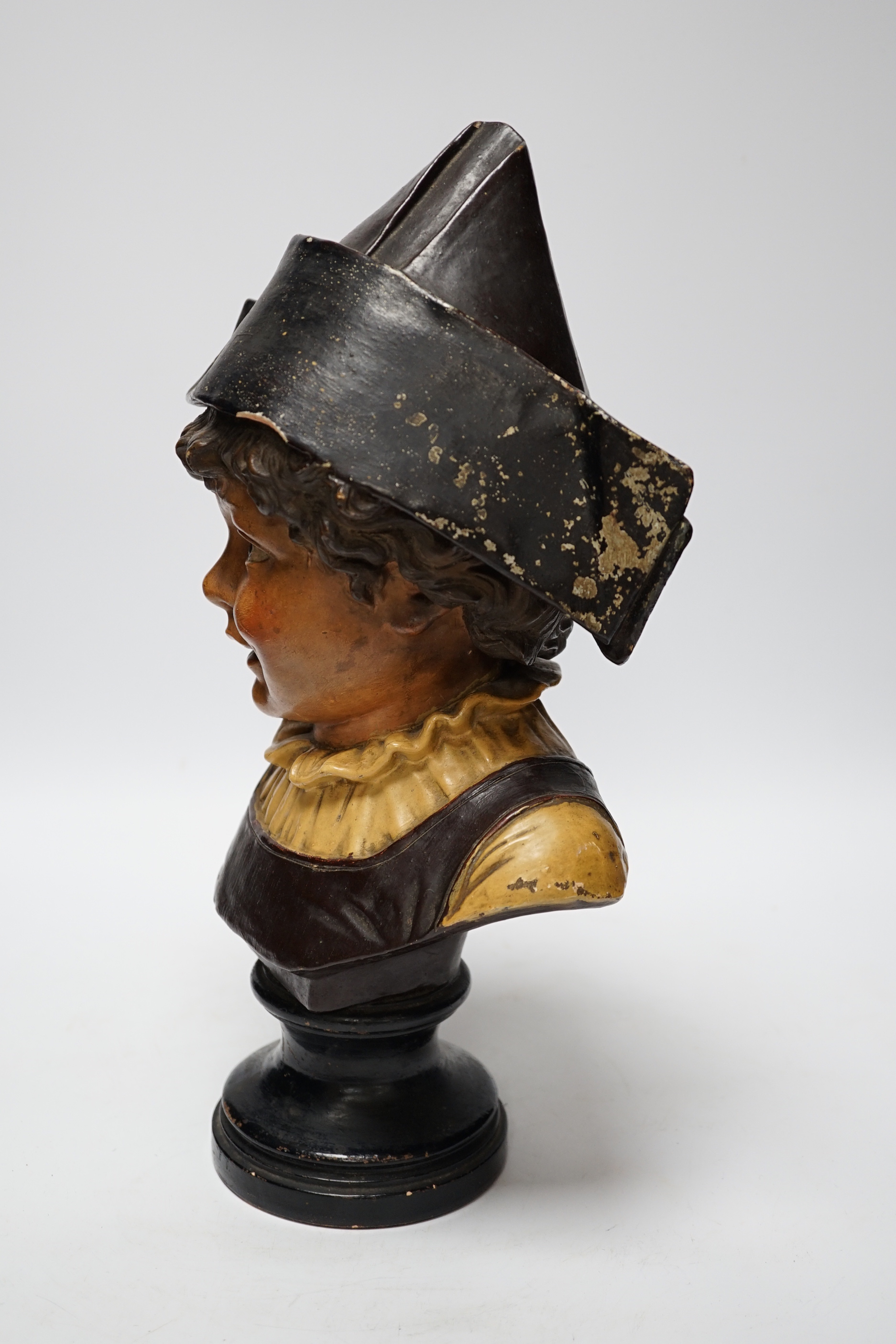 A French cold painted terracotta bust of a child in a bicorn hat on socle plinth, 37cm high